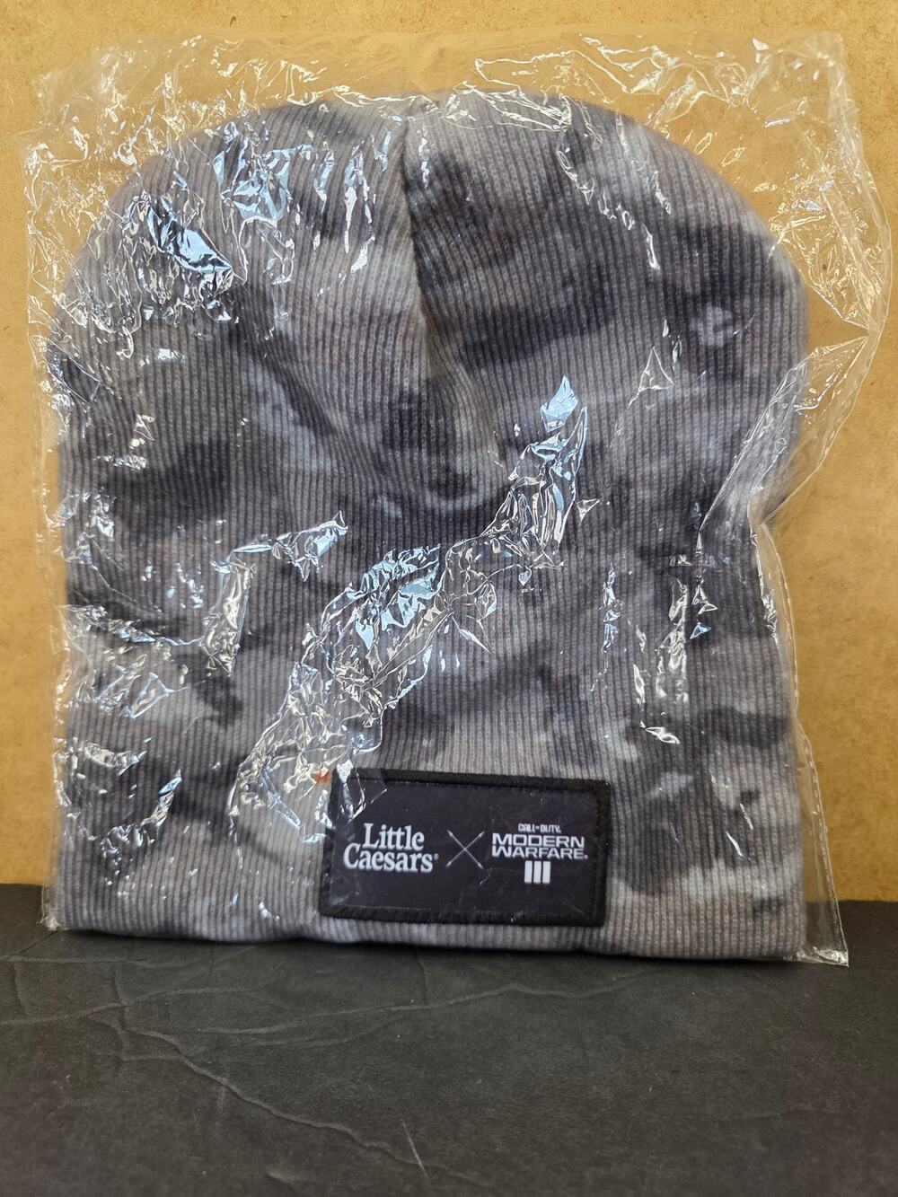 camo/tie-dye knit cuffed beanie Little Caesars and COD: Modern Warfare III.